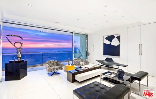 living room featuring a water view and floor to ceiling windows