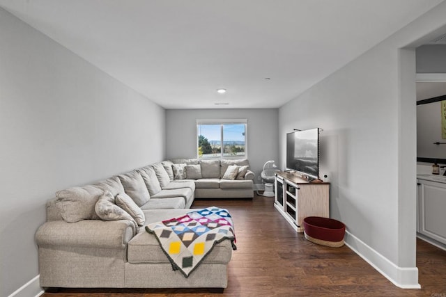 living room with dark hardwood / wood-style flooring