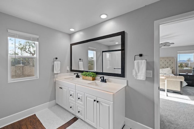 bathroom featuring hardwood / wood-style flooring, ceiling fan, plenty of natural light, and vanity