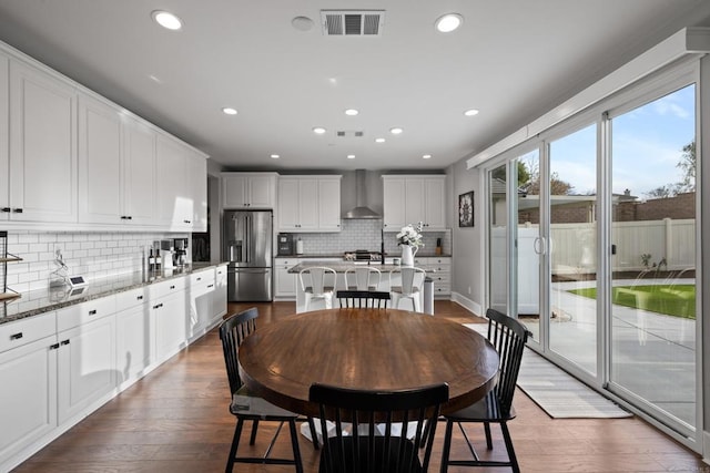 dining space with dark wood-style floors, recessed lighting, and visible vents