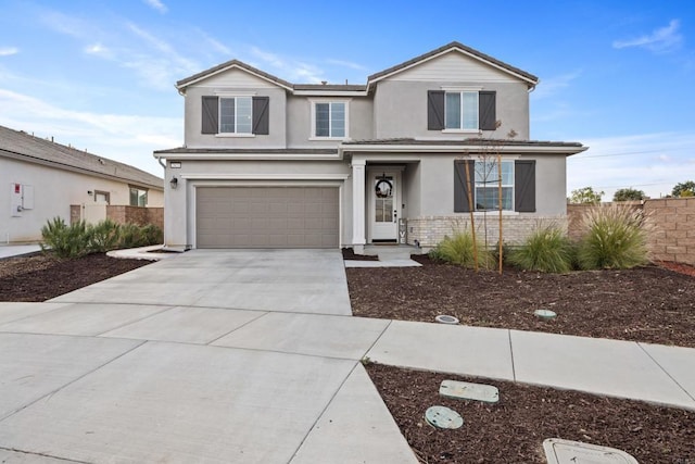 traditional home with stucco siding, fence, concrete driveway, an attached garage, and a tiled roof