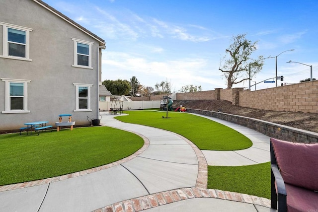 surrounding community with a patio area, a lawn, and a fenced backyard