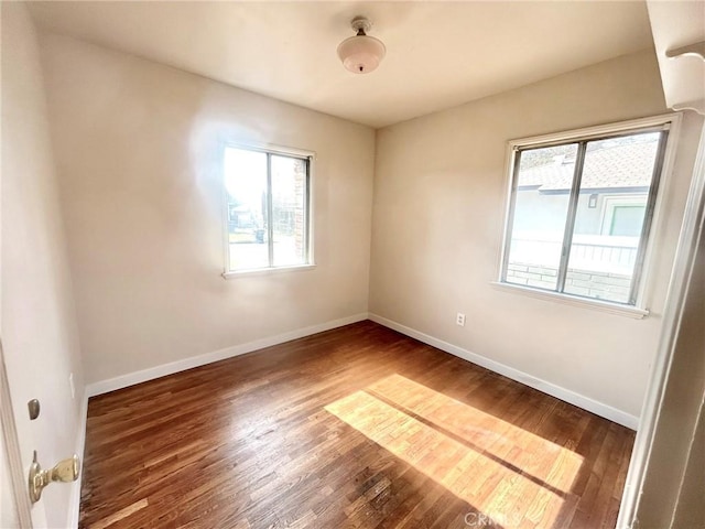 unfurnished room featuring dark hardwood / wood-style flooring