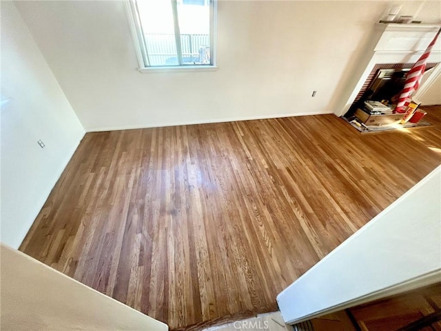 unfurnished room with hardwood / wood-style flooring