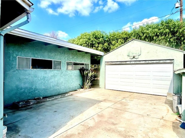 view of side of home with a garage and an outdoor structure