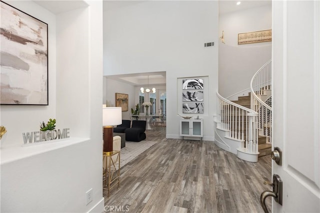 foyer featuring an inviting chandelier and hardwood / wood-style floors