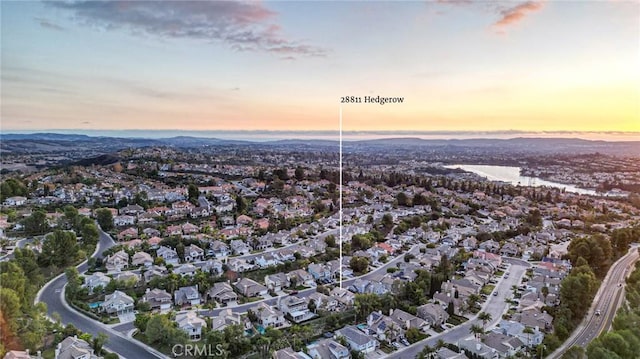 aerial view at dusk featuring a residential view