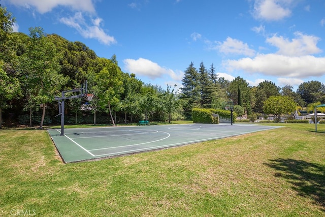 view of basketball court featuring community basketball court and a lawn