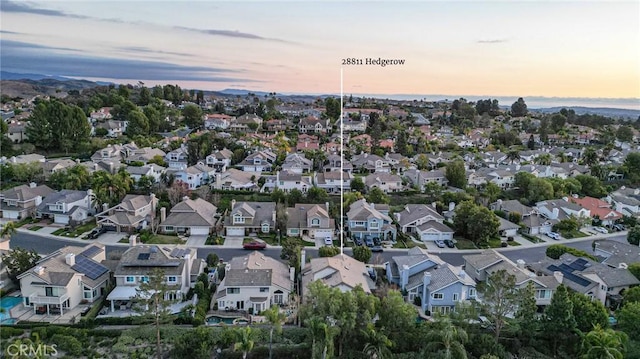 aerial view at dusk featuring a residential view