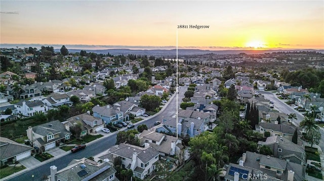 aerial view at dusk featuring a residential view