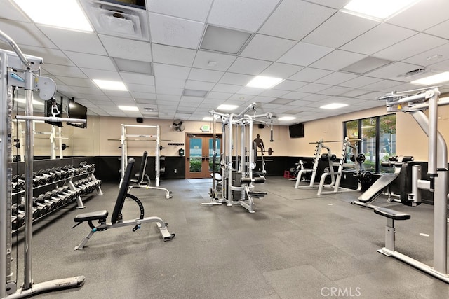 exercise room with a paneled ceiling