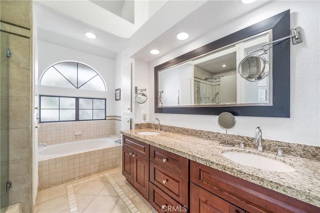 bathroom with a stall shower, recessed lighting, a sink, and tile patterned floors