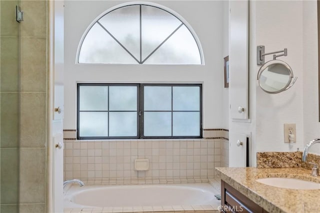 bathroom with vanity and a bath