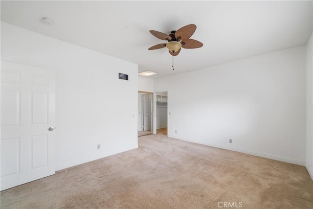 unfurnished room featuring ceiling fan, visible vents, and light colored carpet