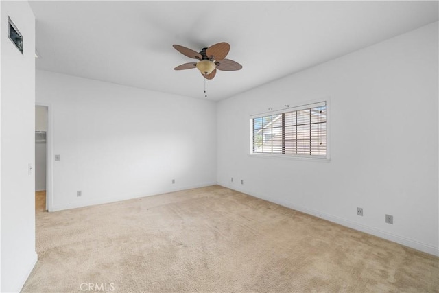 spare room featuring carpet floors and a ceiling fan