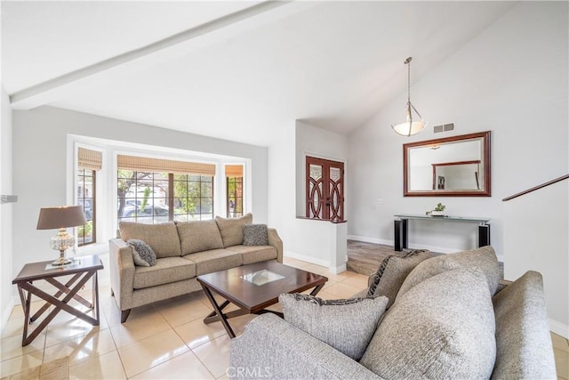 living room featuring light tile patterned floors, baseboards, visible vents, high vaulted ceiling, and beam ceiling