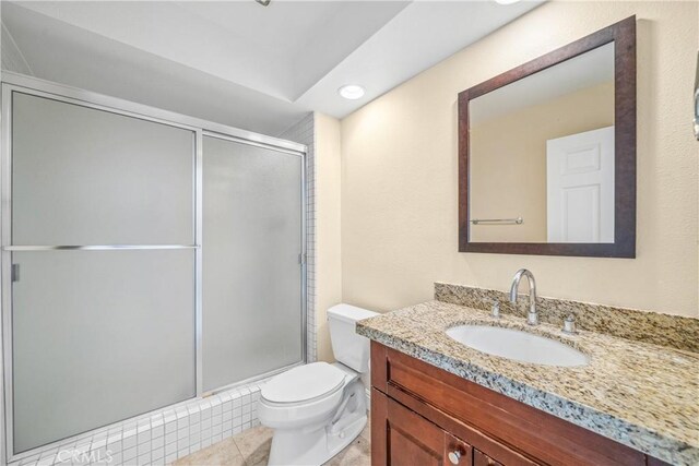 full bathroom with tile patterned floors, vanity, a shower stall, and toilet