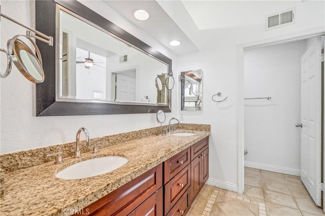 bathroom featuring visible vents, baseboards, and a sink