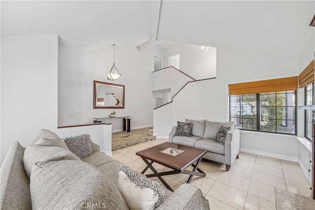 living area with light tile patterned floors, beamed ceiling, baseboards, and high vaulted ceiling