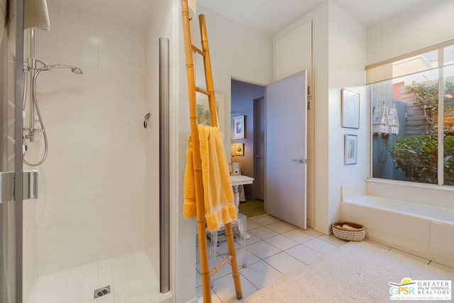 bathroom with separate shower and tub and tile patterned floors