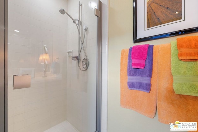 bathroom featuring a shower with door