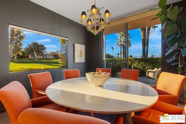 dining space featuring plenty of natural light and a chandelier