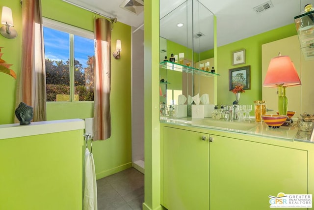 bathroom featuring a healthy amount of sunlight, tile patterned floors, and vanity