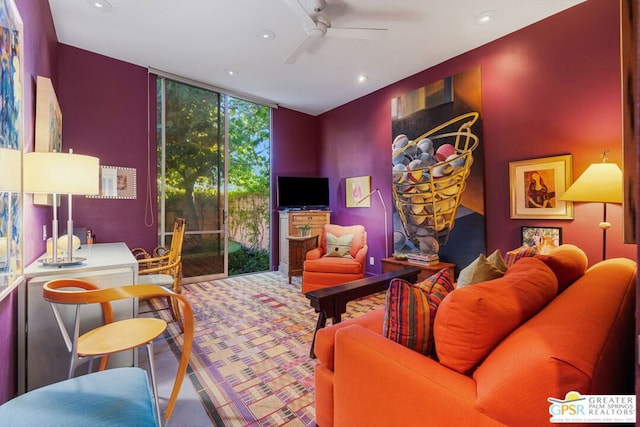 living room featuring ceiling fan, carpet flooring, and floor to ceiling windows