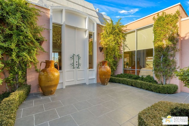 entrance to property with a patio