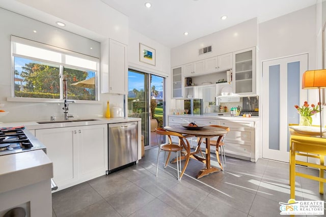 kitchen with white cabinets, dishwasher, and sink