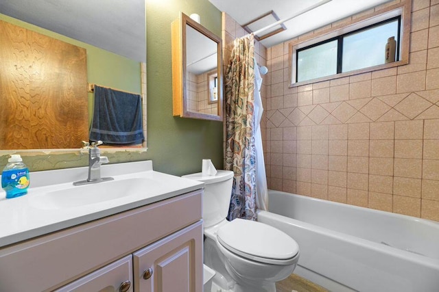 full bathroom featuring toilet, vanity, and shower / bathtub combination with curtain