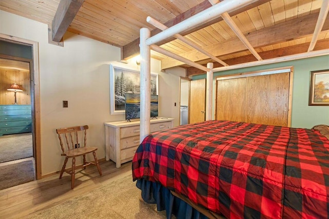 bedroom with light hardwood / wood-style flooring, beamed ceiling, and wooden ceiling