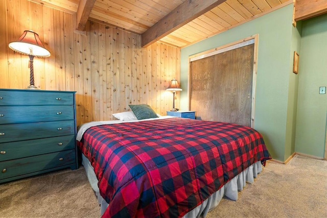 carpeted bedroom with wooden ceiling, a closet, wooden walls, and beamed ceiling