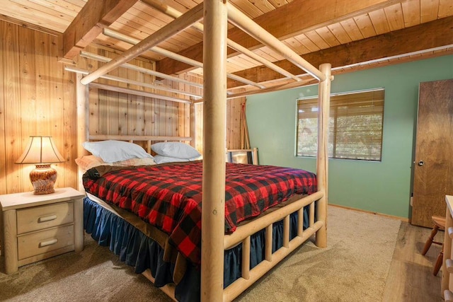 bedroom featuring beam ceiling, wood ceiling, and wooden walls