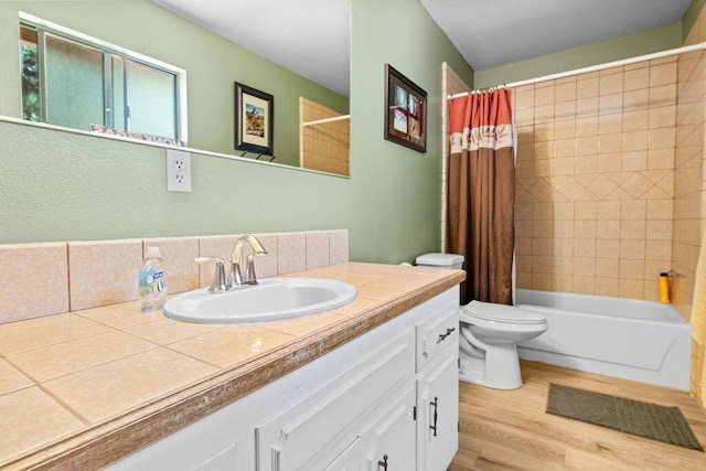 full bathroom with vanity, shower / tub combo, tasteful backsplash, toilet, and hardwood / wood-style flooring