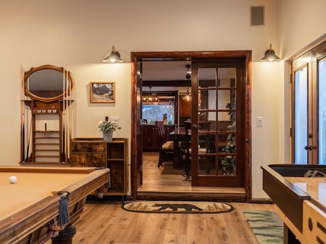 interior space with hardwood / wood-style floors, french doors, and billiards