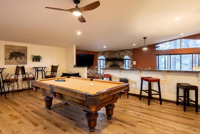 playroom with ceiling fan, pool table, lofted ceiling, a fireplace, and light hardwood / wood-style flooring