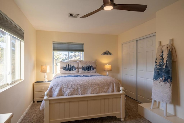 bedroom featuring ceiling fan, multiple windows, a closet, and carpet floors