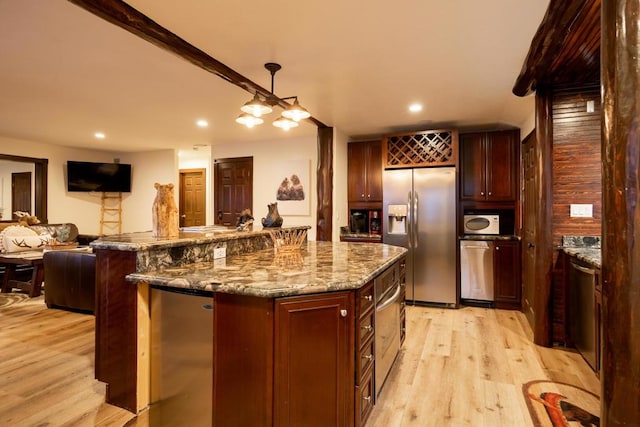 kitchen featuring appliances with stainless steel finishes, a kitchen island, stone counters, light hardwood / wood-style flooring, and beam ceiling