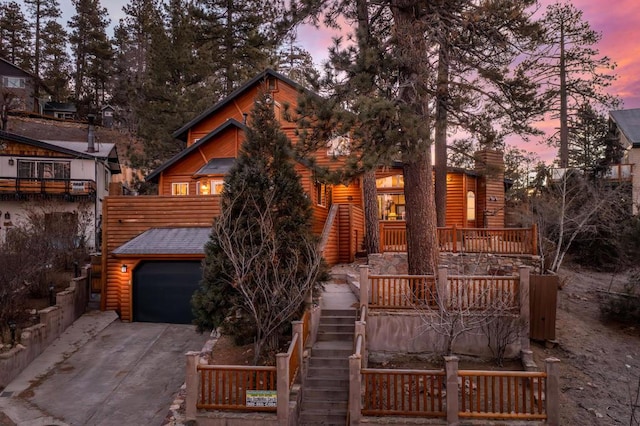 cabin with a garage and a porch