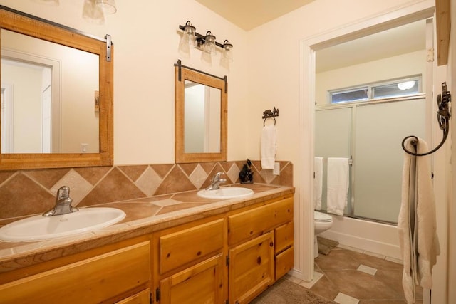 full bathroom featuring tile patterned flooring, enclosed tub / shower combo, tasteful backsplash, and vanity