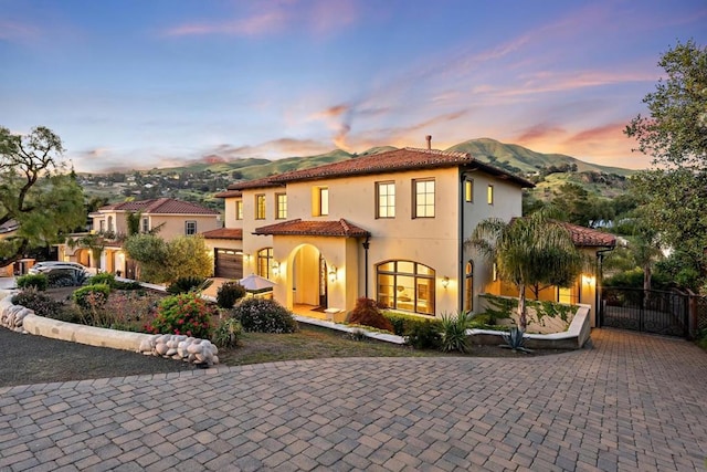 mediterranean / spanish home with a garage and a mountain view