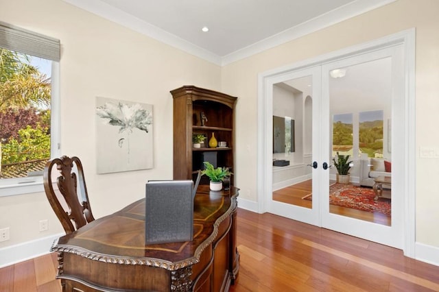 home office with crown molding, hardwood / wood-style floors, and french doors