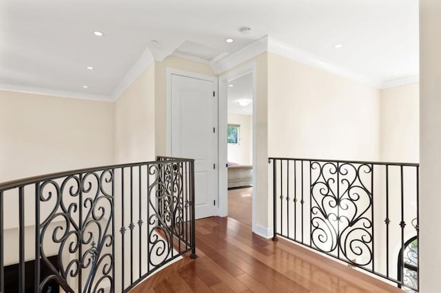 corridor with crown molding and hardwood / wood-style floors