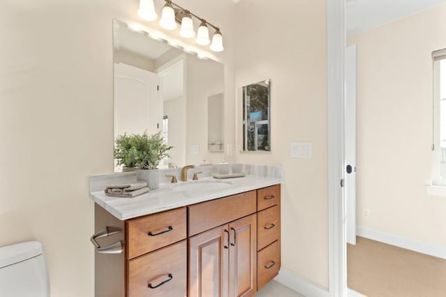 bathroom featuring toilet and vanity