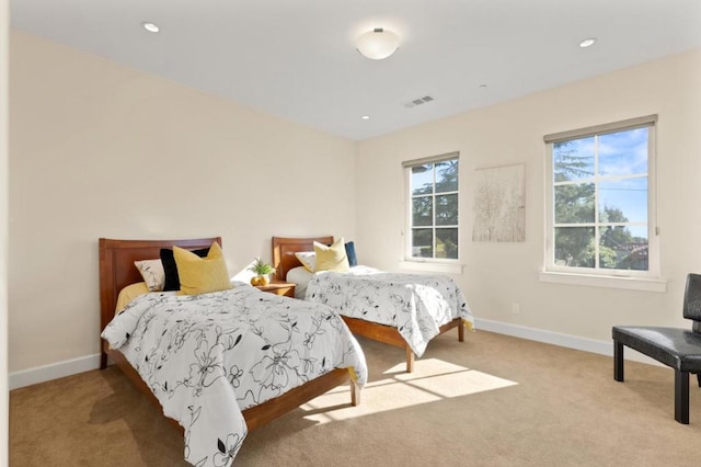 carpeted bedroom featuring multiple windows