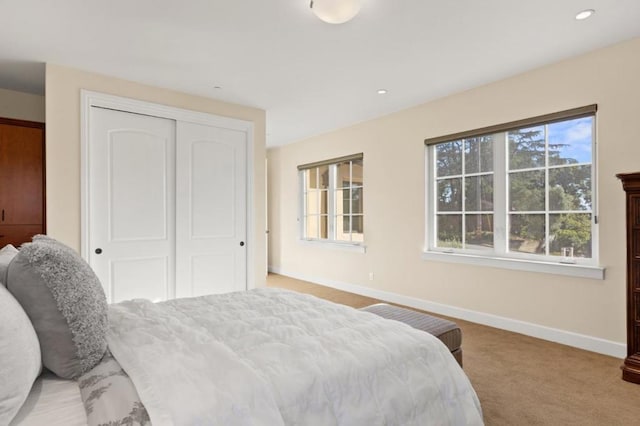 carpeted bedroom with a closet