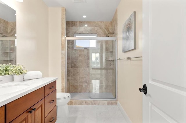 bathroom featuring an enclosed shower, vanity, toilet, and tile patterned flooring