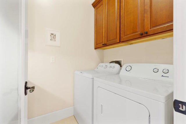 laundry room with cabinets and washer and clothes dryer