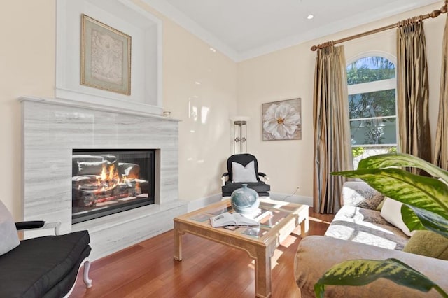 living room featuring crown molding and light wood-type flooring